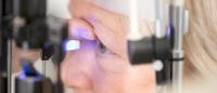 woman having eyes examined by ophthalmologist